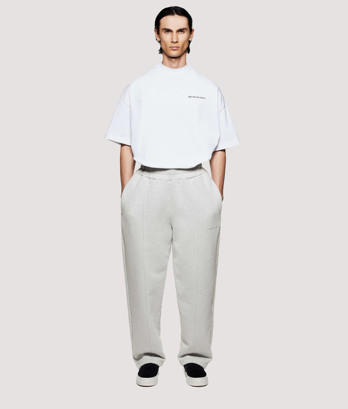 MKI MIYUKI ZOKU Relaxed Fit 800 GSM Superweight Wide Leg Joggers in Oatmeal at EQVVS Menswear. Model front shot.