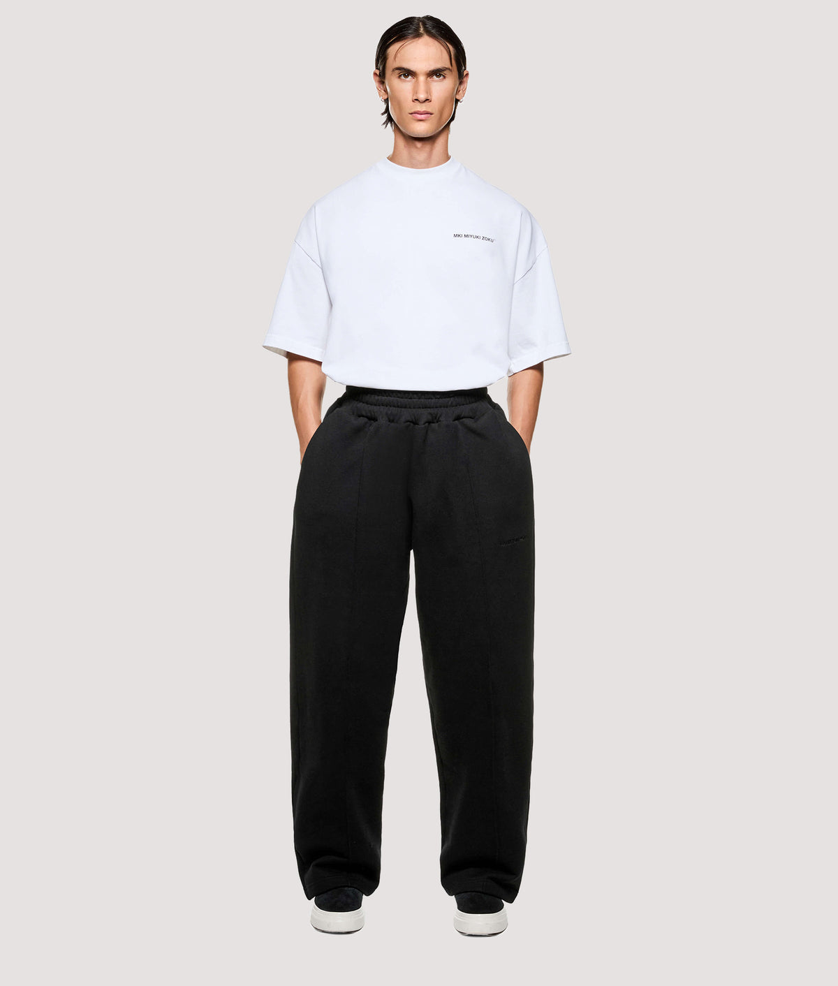 MKI MIYUKI ZOKU Relaxed Fit 800 GSM Superweight Wide Leg Joggers in Black at EQVVS Menswear. Model front shot.