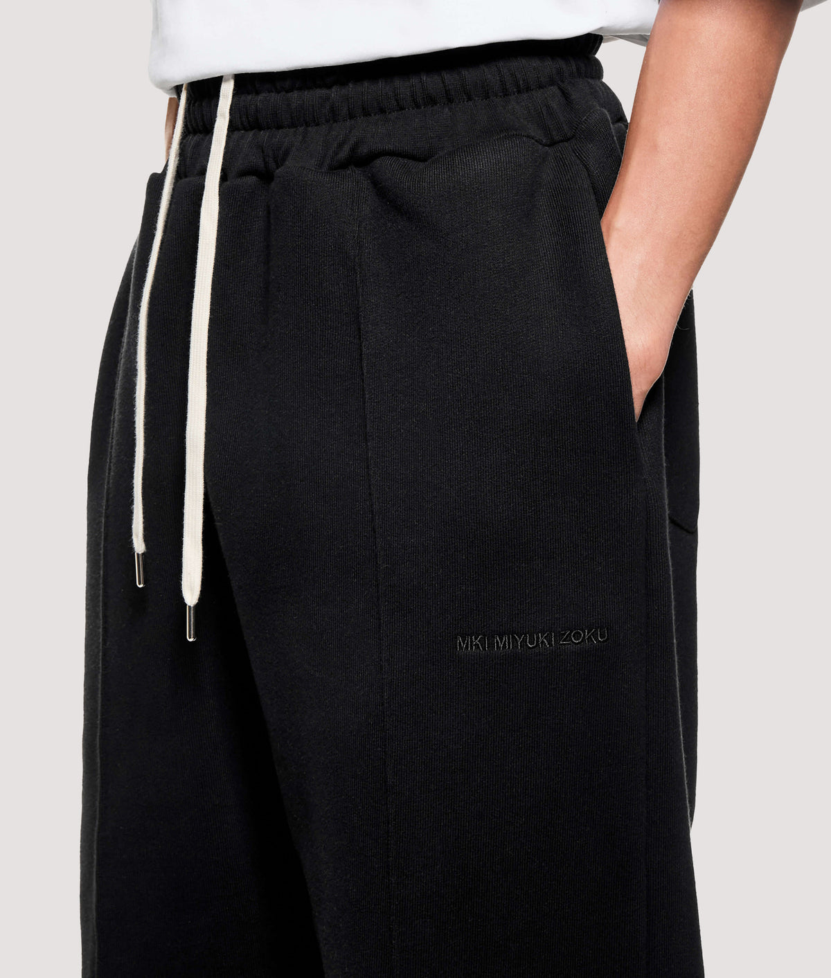MKI MIYUKI ZOKU Relaxed Fit 800 GSM Superweight Wide Leg Joggers in Black at EQVVS Menswear. Detail shot.