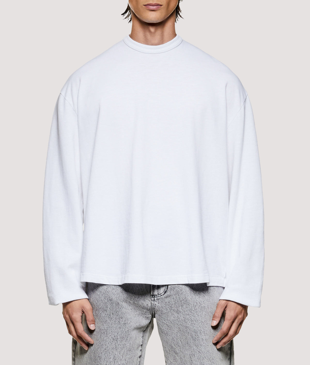 MKI MIYUKI ZOKU Relaxed Fit 220 GSM Slub Long Sleeve T-Shirt in White at EQVVS Menswear. Model front shot.