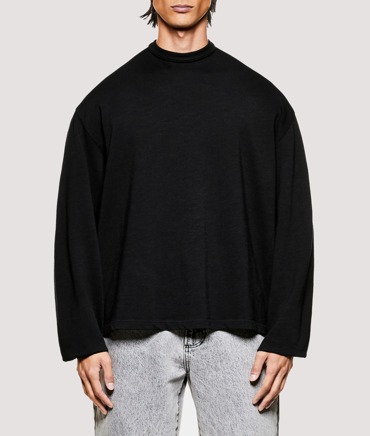 MKI MIYUKI ZOKU Relaxed Fit 220 GSM Slub Long Sleeve T-Shirt in Black at EQVVS Menswear. Model front shot.