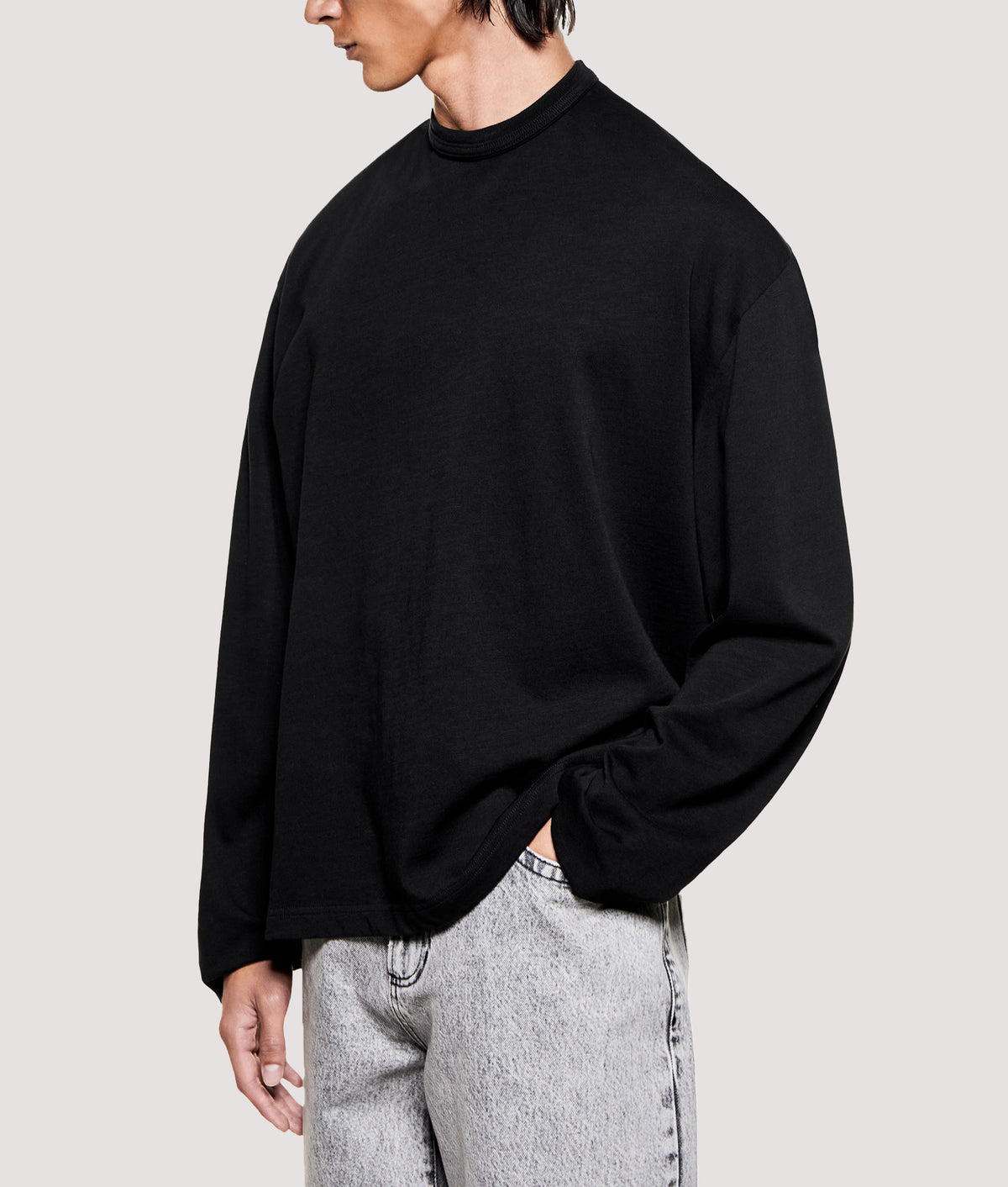 MKI MIYUKI ZOKU Relaxed Fit 220 GSM Slub Long Sleeve T-Shirt in Black at EQVVS Menswear. Angled model front shot.