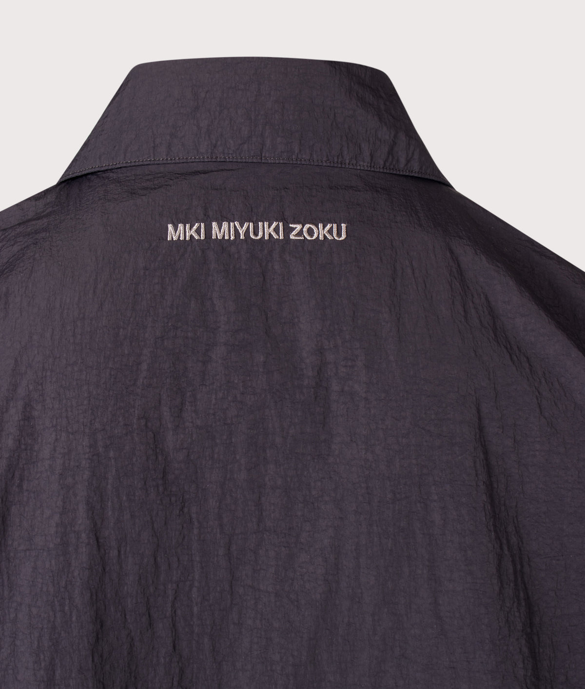 MKI MIYUKI ZOKU Relaxed Fit Garment Dyed Field Overshirt in Vintage Black at EQVVS Menswear. Back shot.