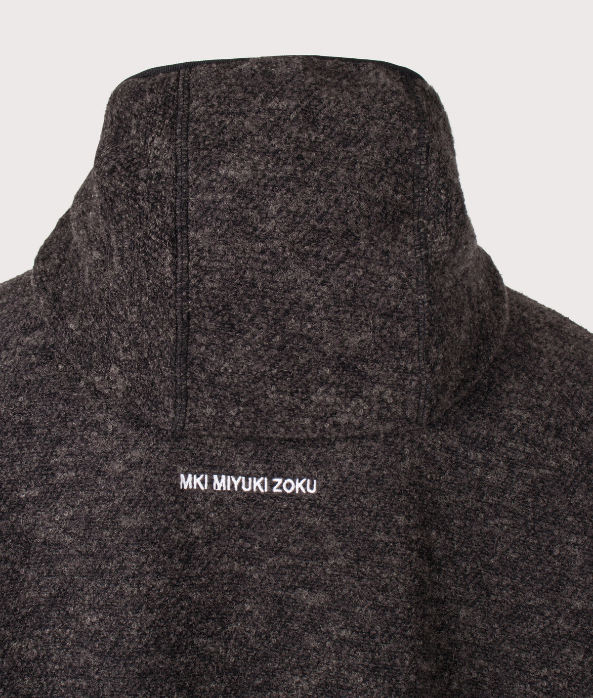 MKI MIYUKI ZOKU Relaxed Box Fit Boucle Zip Through Hoodie in Charcoal Melange at EQVVS Menswear. Back detail shot.