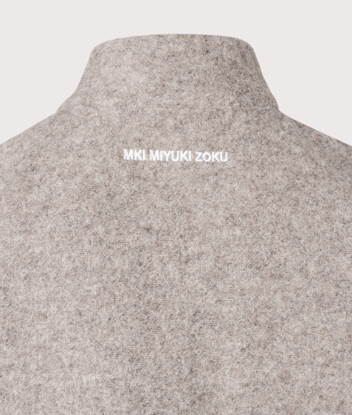 MKI MIYUKI ZOKU Relaxed Box Fit Pressed Wool Track Jacket in Oatmeal Melange at EQVVS Menswear. Detail shot.