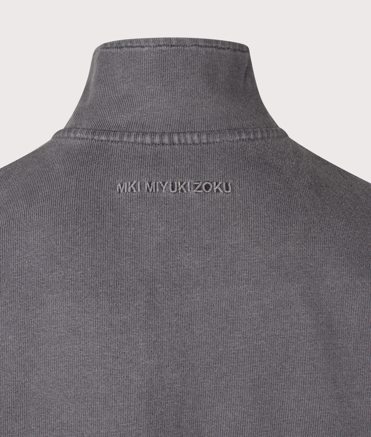 MKI MIYUKI ZOKU Relaxed Fit 400 GSM Pigment Dyed Track Jacket in Pigment Black at EQVVS Menswear. Detail shot.
