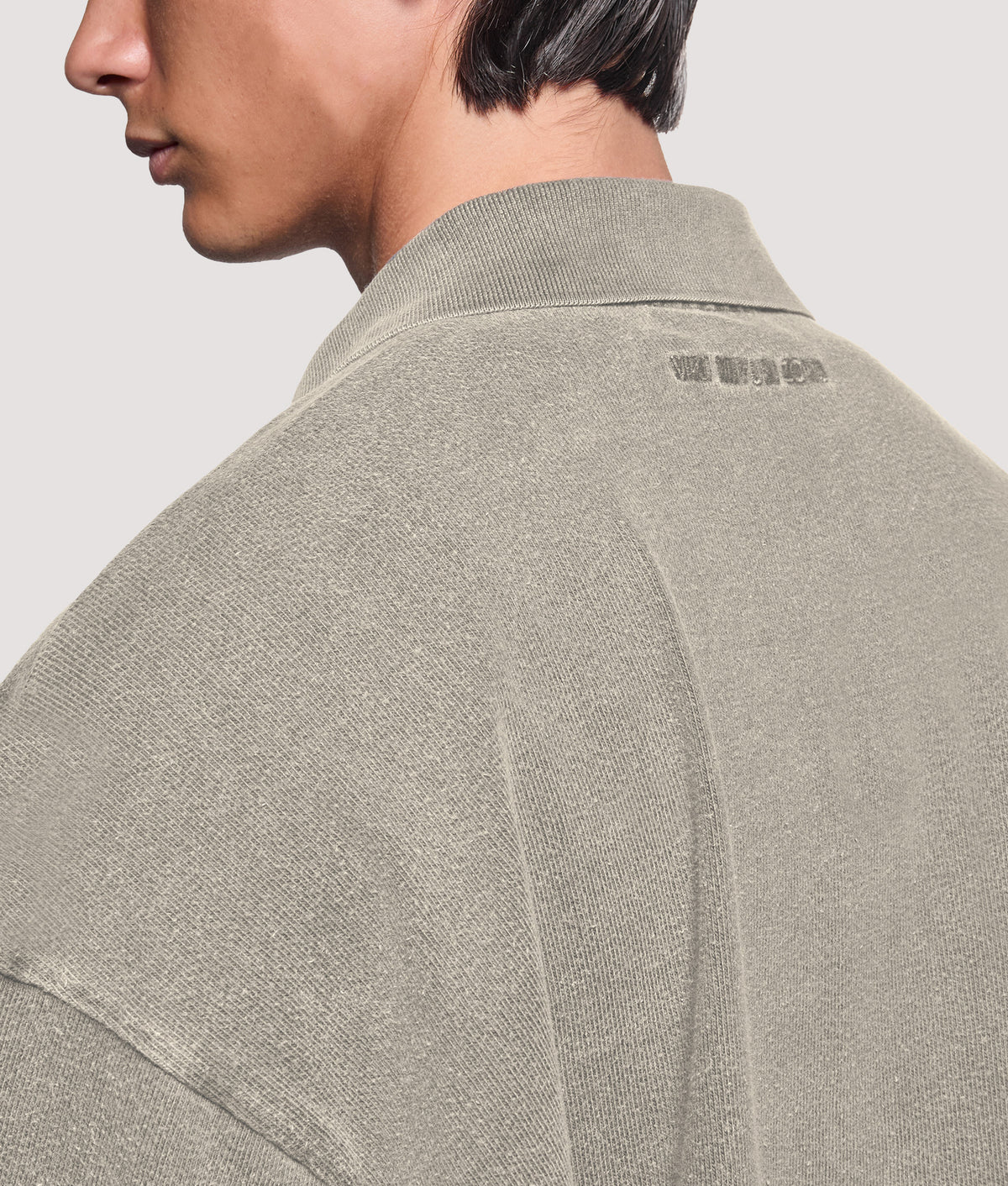 MKI MIYUKI ZOKU Relaxed Box Fit 400 GSM Pigment Dyed Rugby Shirt in Pigment Stone at EQVVS Menswear. Angled back shot.