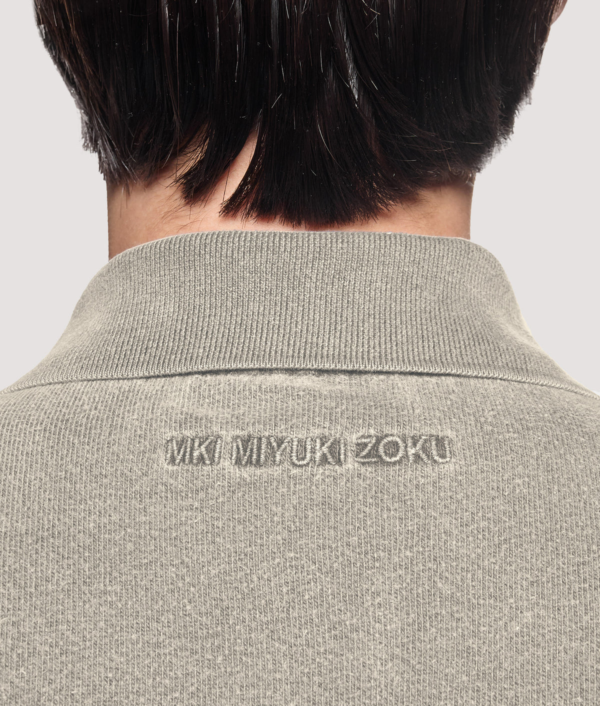MKI MIYUKI ZOKU Relaxed Box Fit 400 GSM Pigment Dyed Rugby Shirt in Pigment Stone at EQVVS Menswear. Back detail shot.