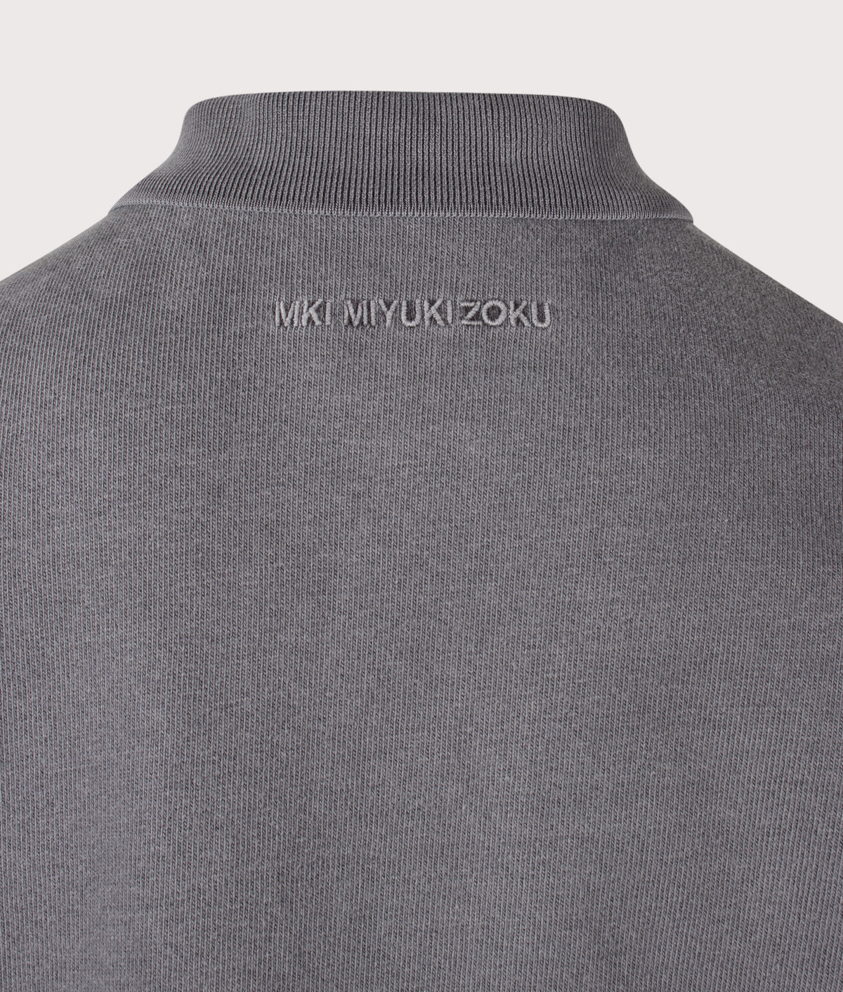 MKI MIYUKI ZOKU Relaxed Box Fit 400 GSM Pigment Dyed Rugby Shirt in Pigment Black at EQVVS Menswear. Detail shot.