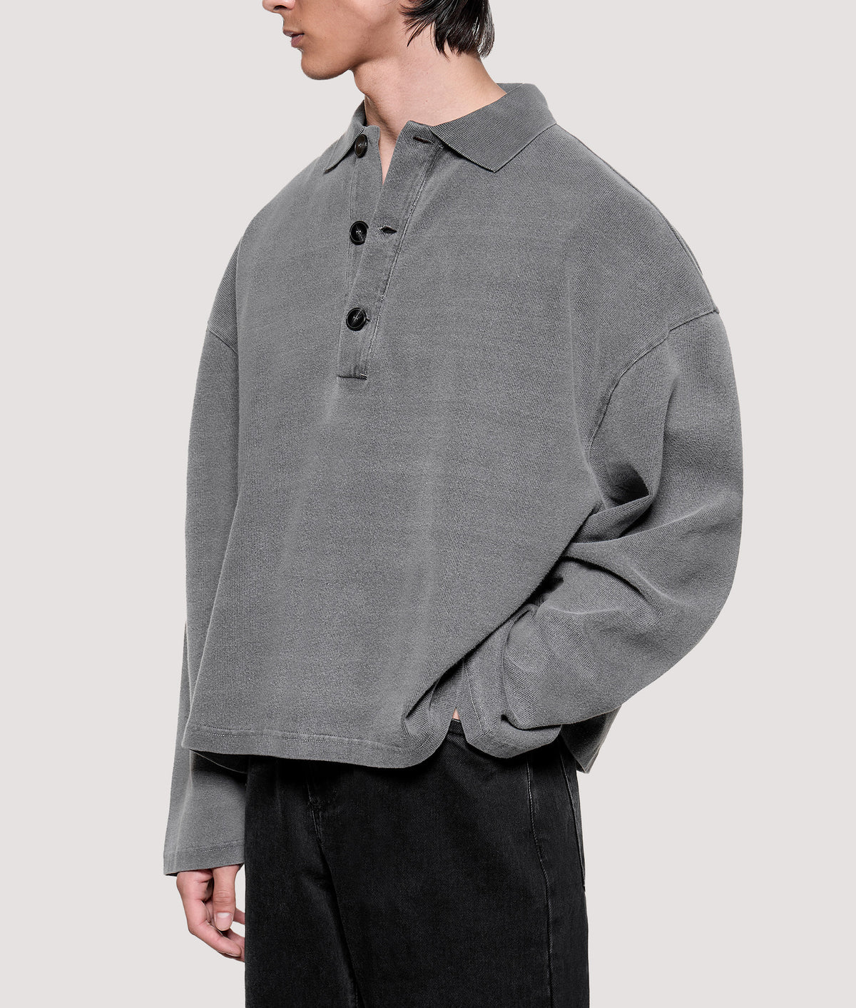 MKI MIYUKI ZOKU Relaxed Box Fit 400 GSM Pigment Dyed Rugby Shirt in Pigment Black at EQVVS Menswear. Angled model front shot.