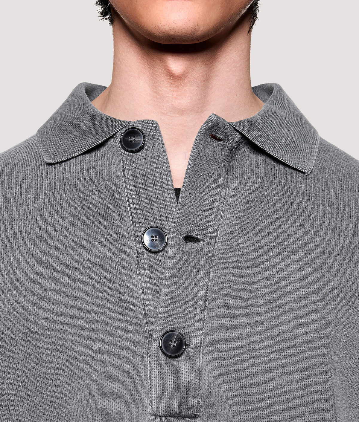 MKI MIYUKI ZOKU Relaxed Box Fit 400 GSM Pigment Dyed Rugby Shirt in Pigment Black at EQVVS Menswear. Placket detail shot.