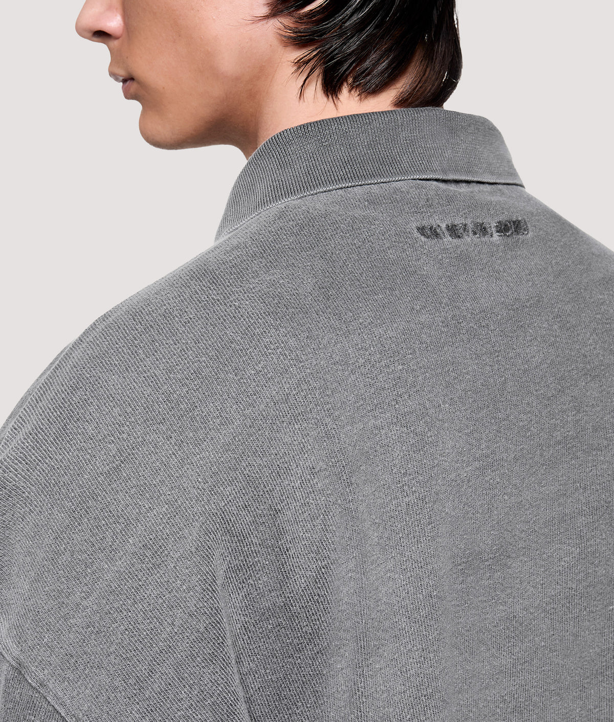 MKI MIYUKI ZOKU Relaxed Box Fit 400 GSM Pigment Dyed Rugby Shirt in Pigment Black at EQVVS Menswear. Angled back shot.