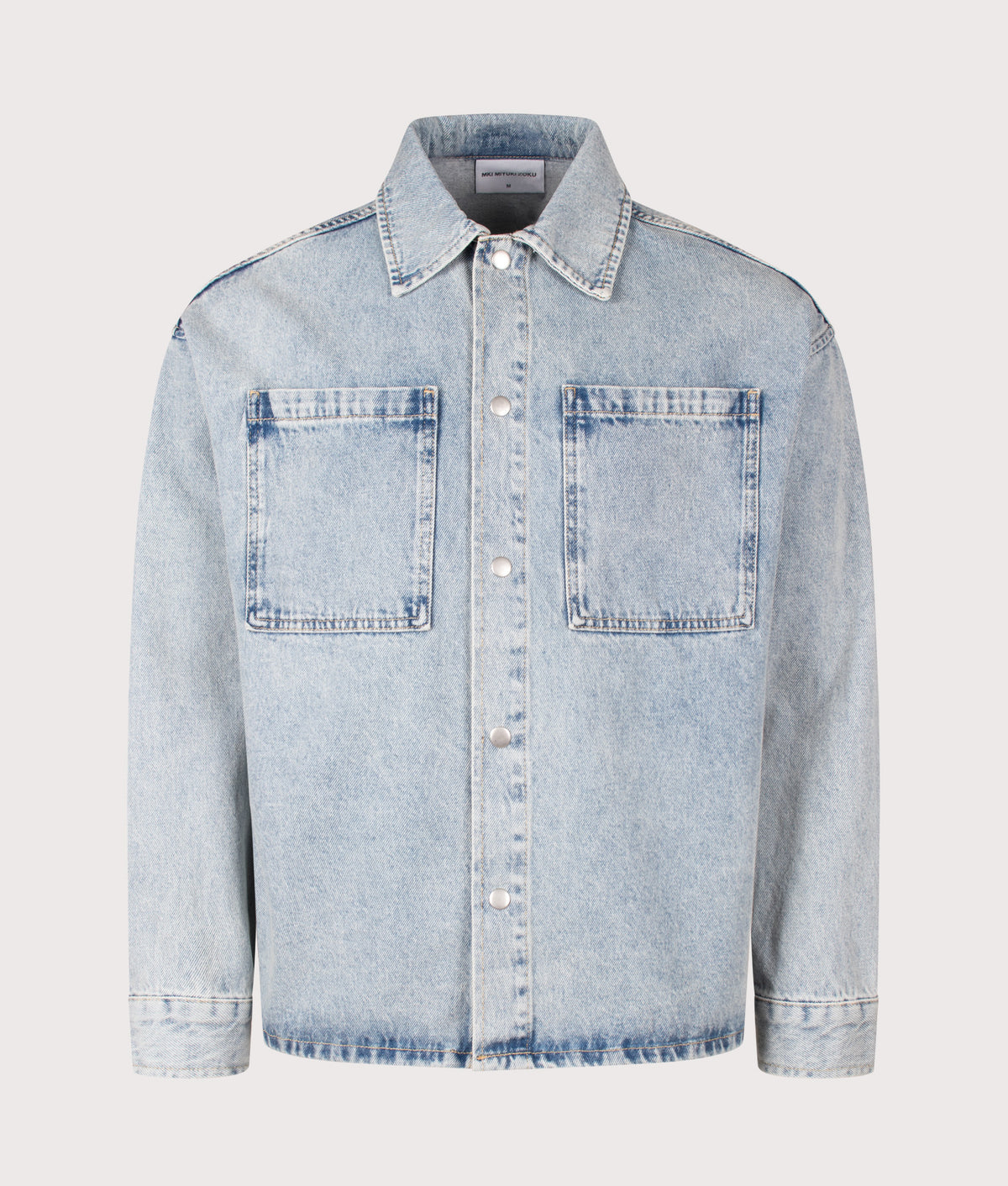 MKI MIYUKI ZOKU Relaxed Box Fit Denim Box Overshirt in Bleach Wash at EQVVS Menswear. Front shot.