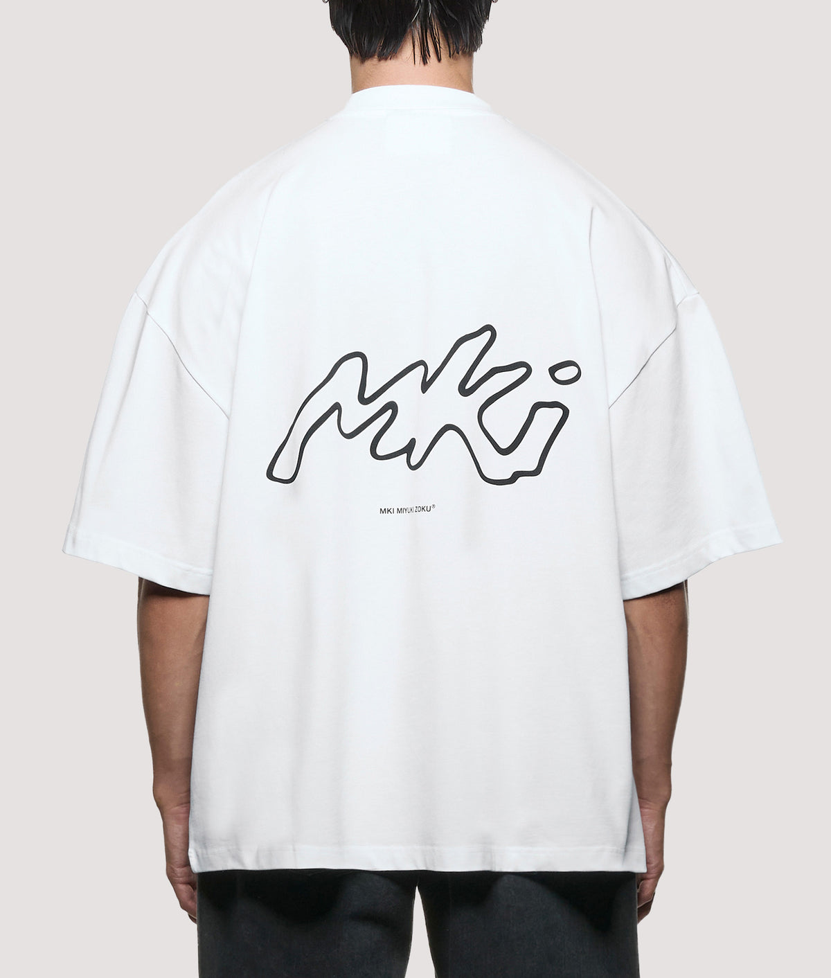 MKI MIYUKI ZOKU Oversized Box Fit Ink Line T-Shirt in White at EQVVS Menswear. Model back shot.