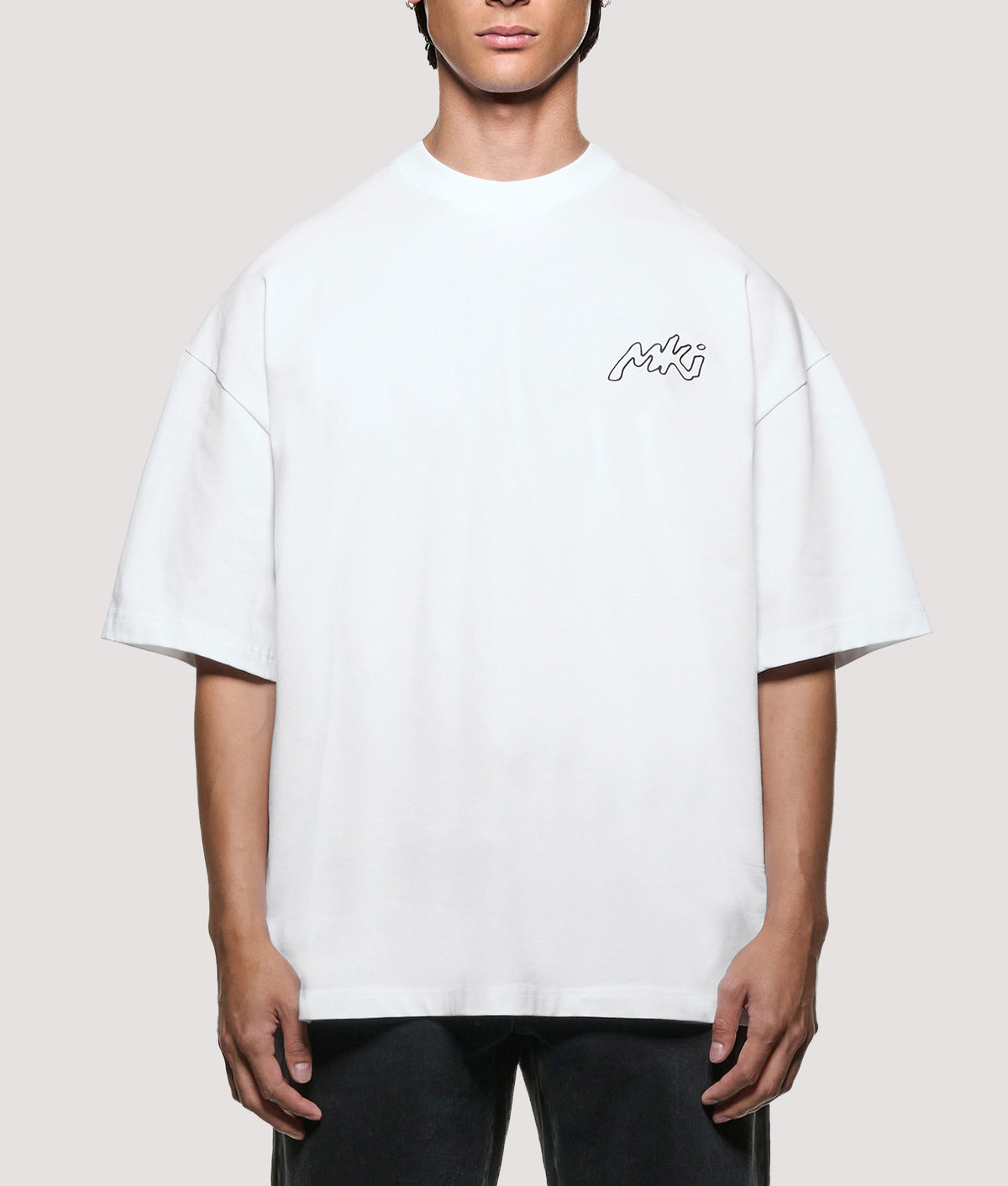 MKI MIYUKI ZOKU Oversized Box Fit Ink Line T-Shirt in White at EQVVS Menswear. Model front shot.