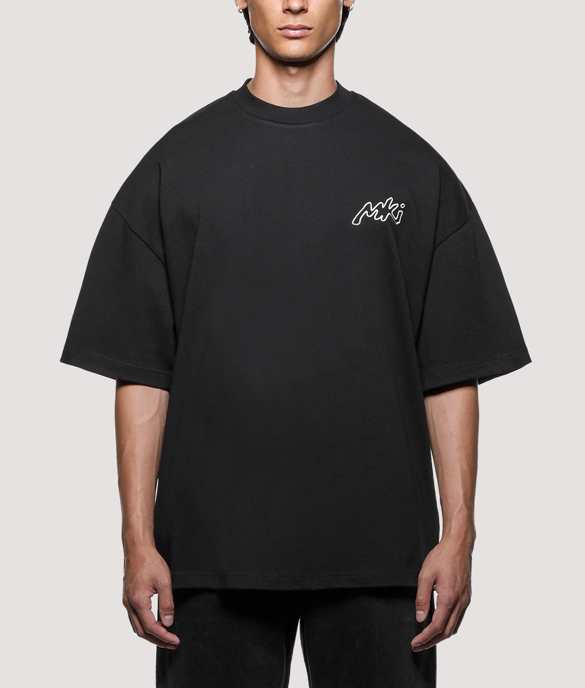 MKI MIYUKI ZOKU Oversized Box Fit Ink Line T-Shirt in Black at EQVVS Menswear.  Model front shot.