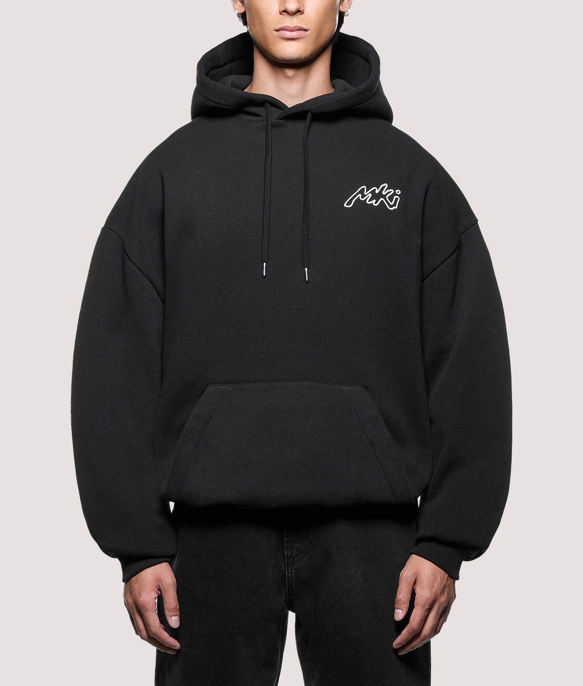 MKI MIYUKI ZOKU Oversized Box Fit Ink Line Hoodie in Black at EQVVS Menswear. Model front shot.