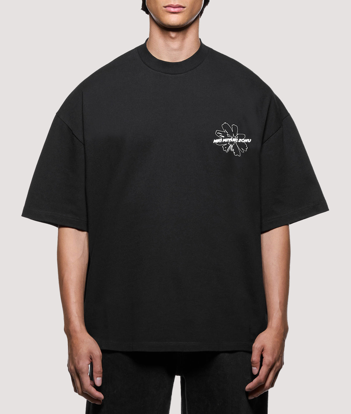 MKI MIYUKI ZOKU Oversized Box Fit Wildflower T-Shirt in Black at EQVVS Menswear. Model front shot.