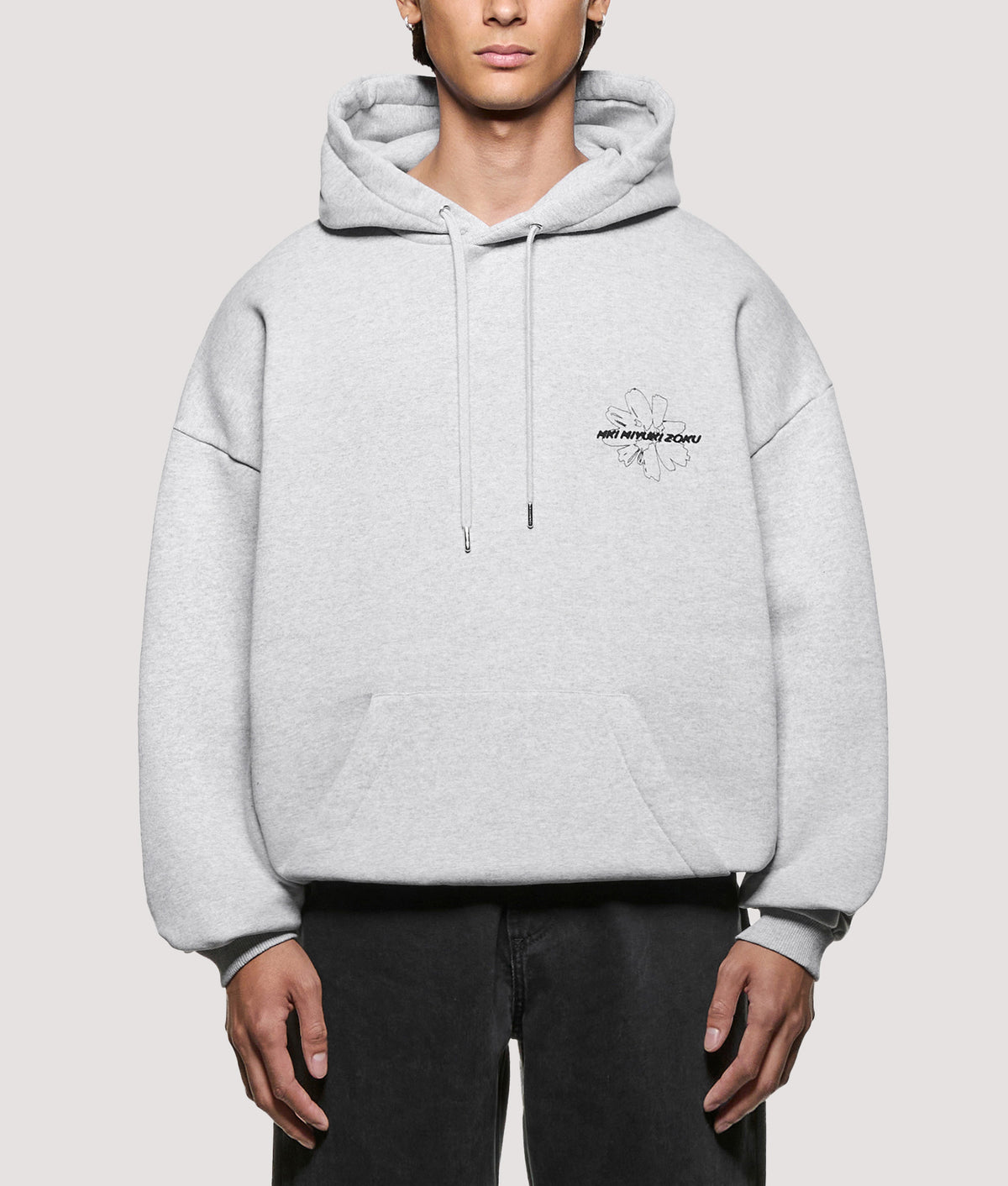 MKI MIYUKI ZOKU Oversized Box Fit Wildflower Hoodie in Grey at EQVVS Menswear. Model front shot.