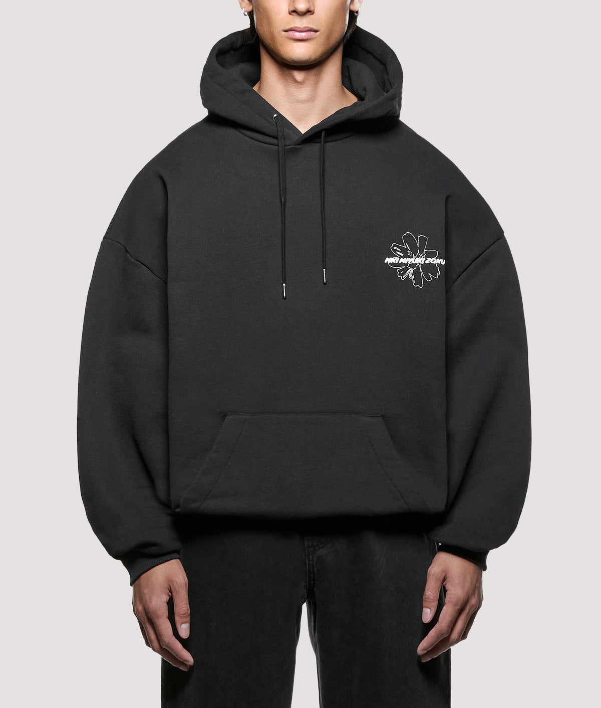 MKI MIYUKI ZOKU Oversized Box Fit Wildflower Hoodie in Black at EQVVS Menswear. Model front shot.