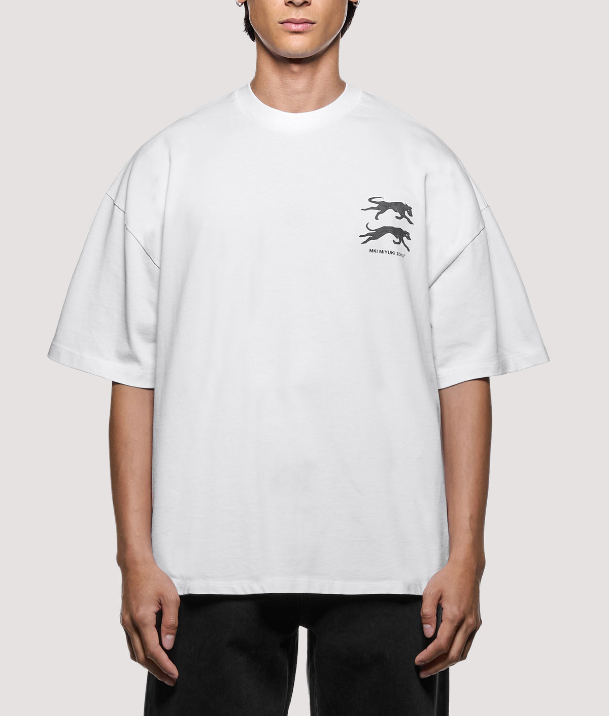 MKI MIYUKI ZOKU Oversized Box Fit Greyhound T-Shirt in White at EQVVS Menswear. Model front shot.
