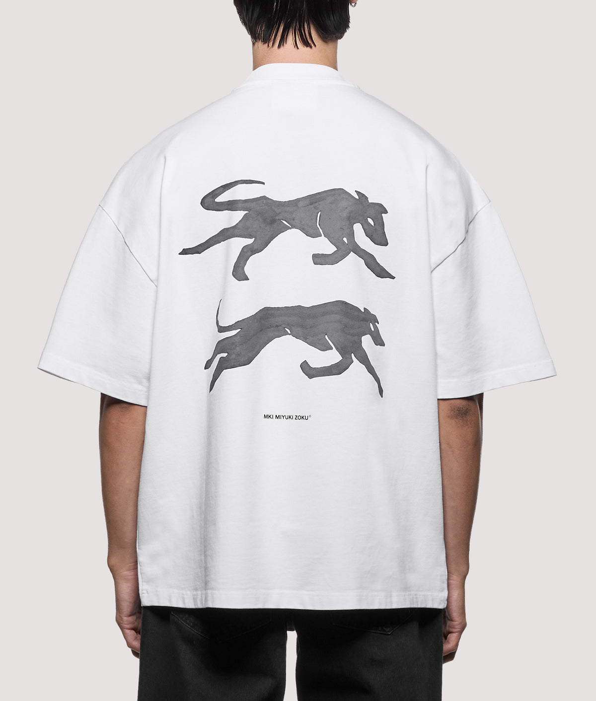 MKI MIYUKI ZOKU Oversized Box Fit Greyhound T-Shirt in White at EQVVS Menswear. Model back  shot.