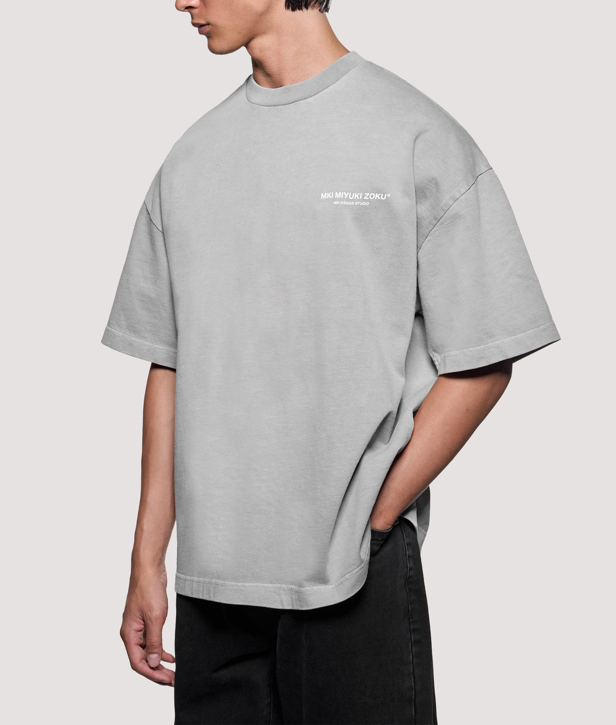 MKI MIYUKI ZOKU Oversized Box Fit Design Studio T-Shirt in Pigment Stone at EQVVS Menswear. Angled model front shot.