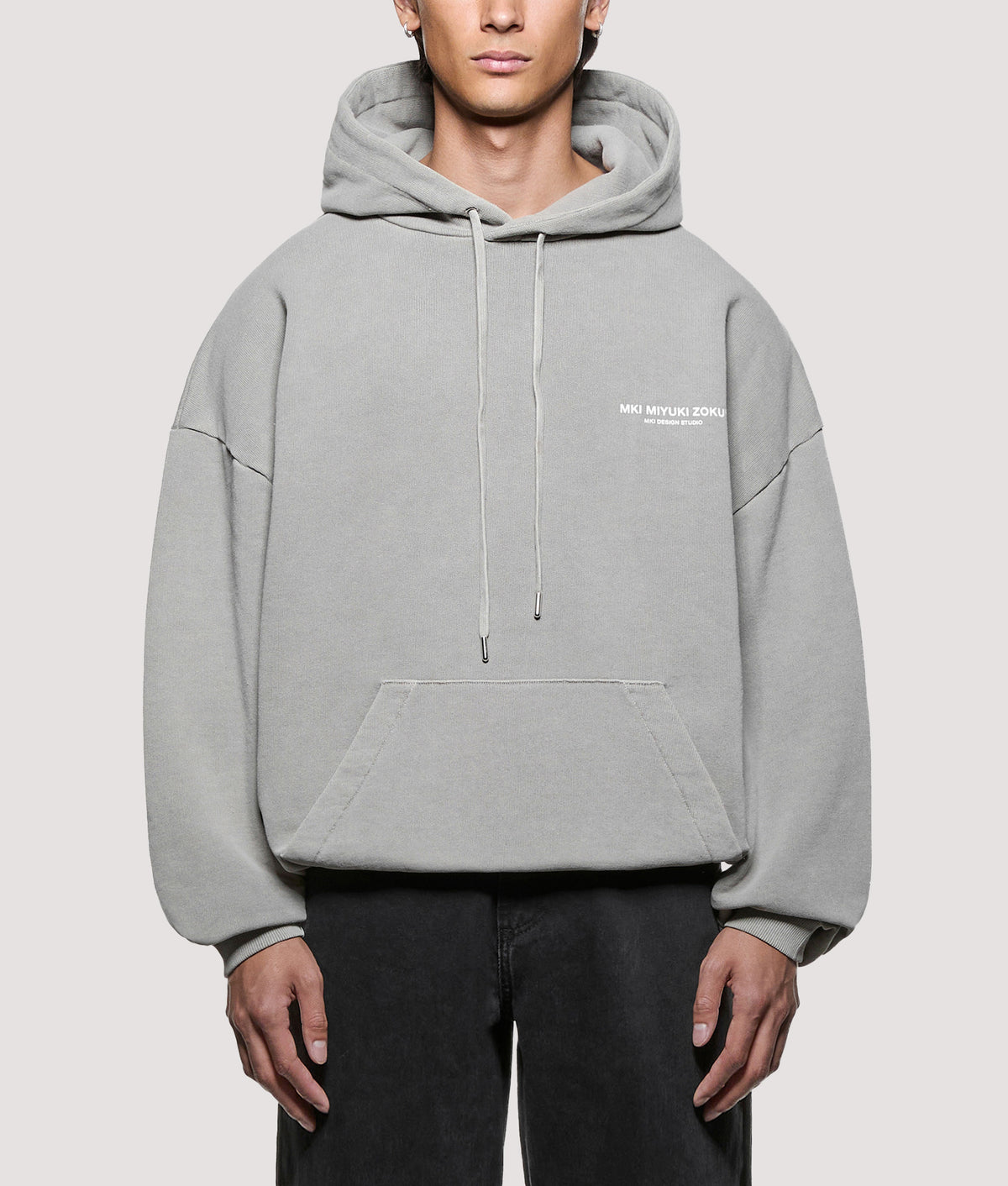 MKI MIYUKI ZOKU Oversized Box Fit Design Studio Hoodie in Pigment Stone at EQVVS Menswear. Model front shot.