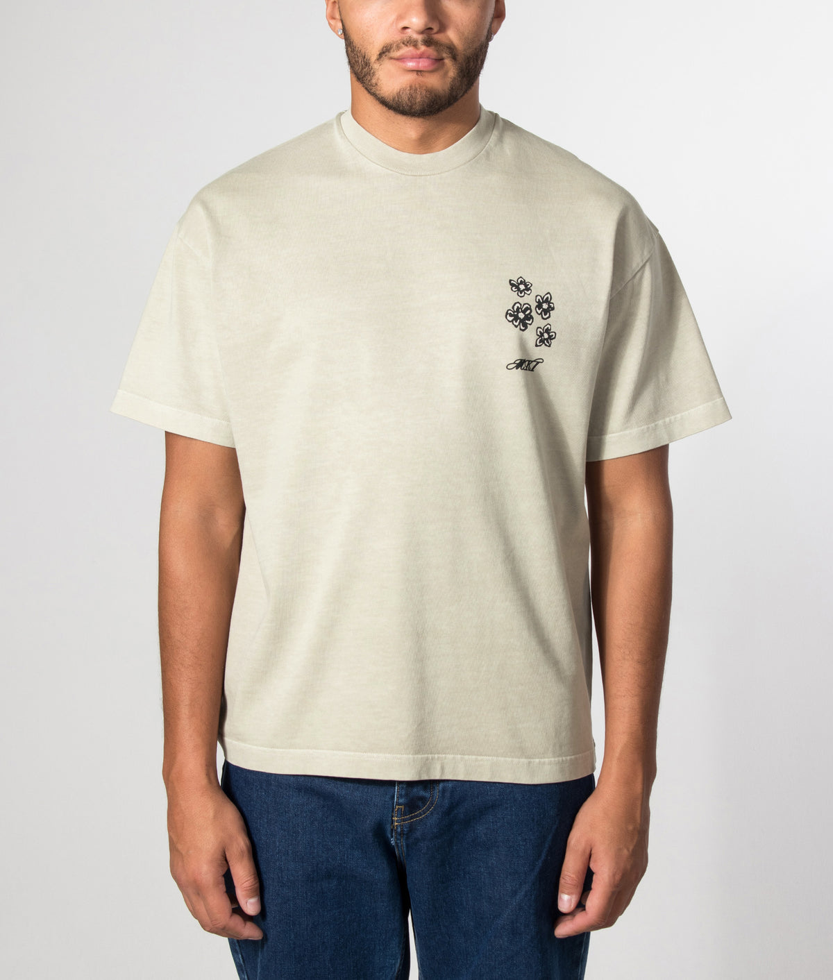 MKI MIYUKI ZOKU Box Fit Hibiscus T-Shirt in Pigment Cement at EQVVS Menswear. Model front shot.