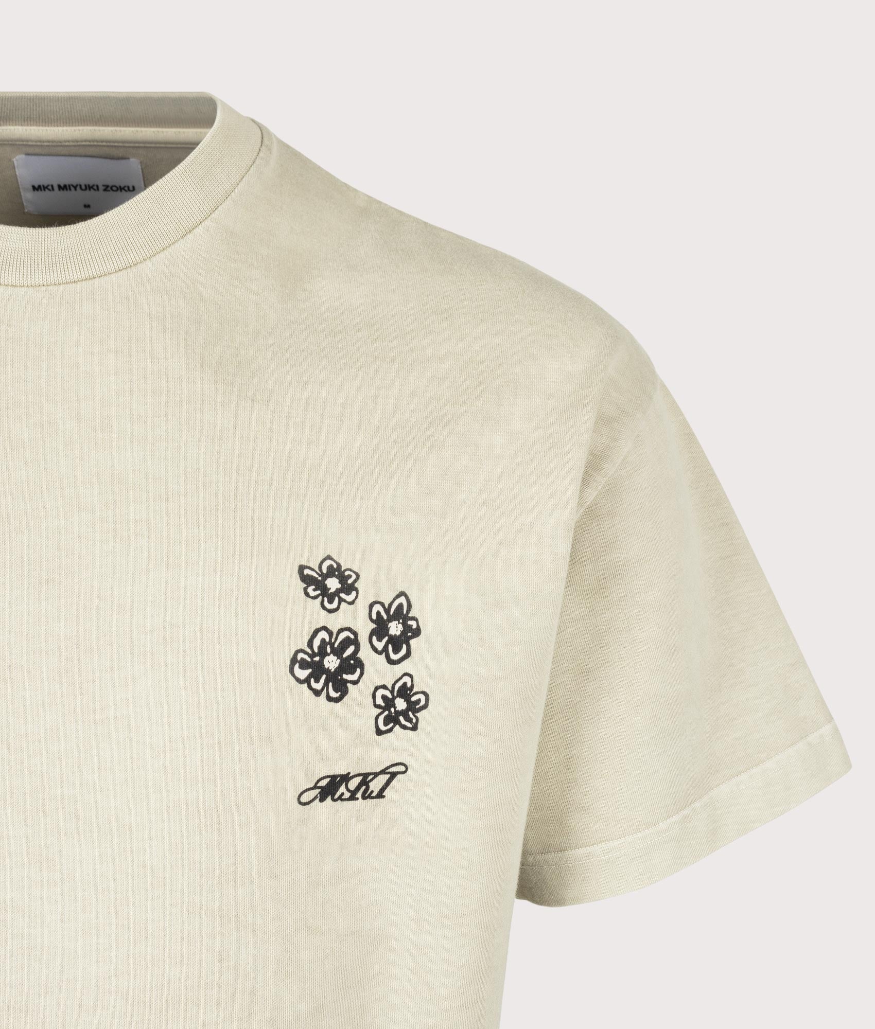 MKI MIYUKI ZOKU Box Fit Hibiscus T-Shirt in Pigment Cement at EQVVS Menswear. Detail shot.