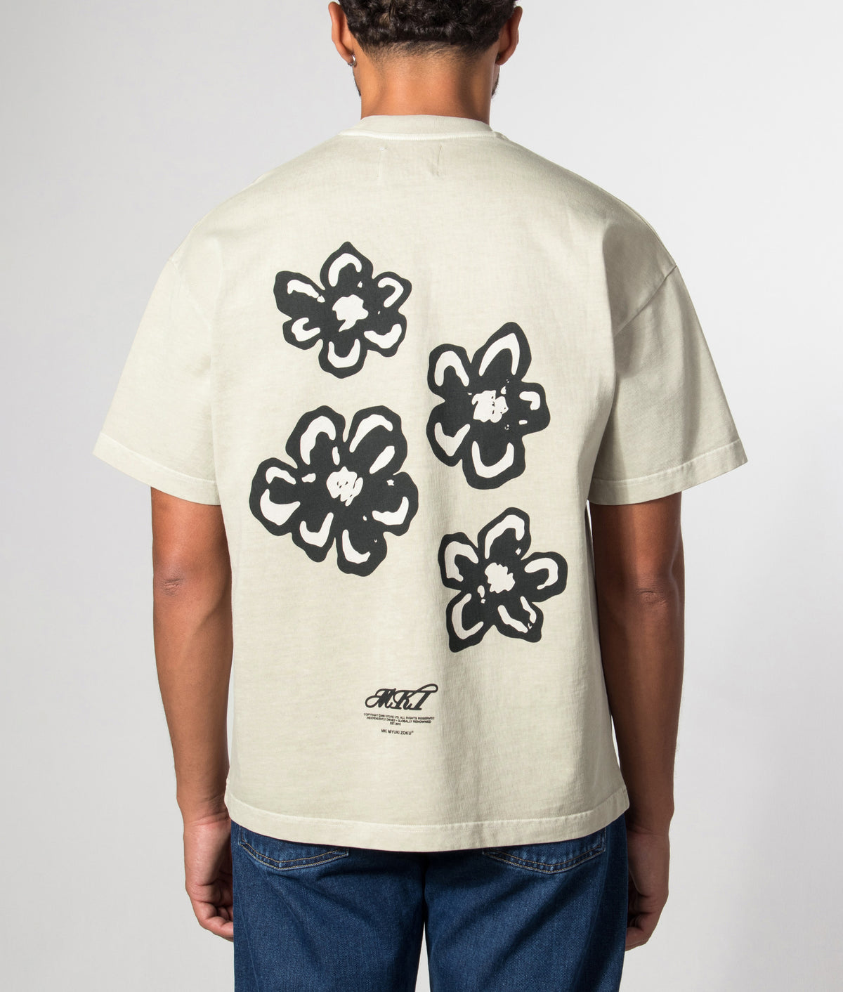 MKI MIYUKI ZOKU Box Fit Hibiscus T-Shirt in Pigment Cement at EQVVS Menswear. Model back shot.
