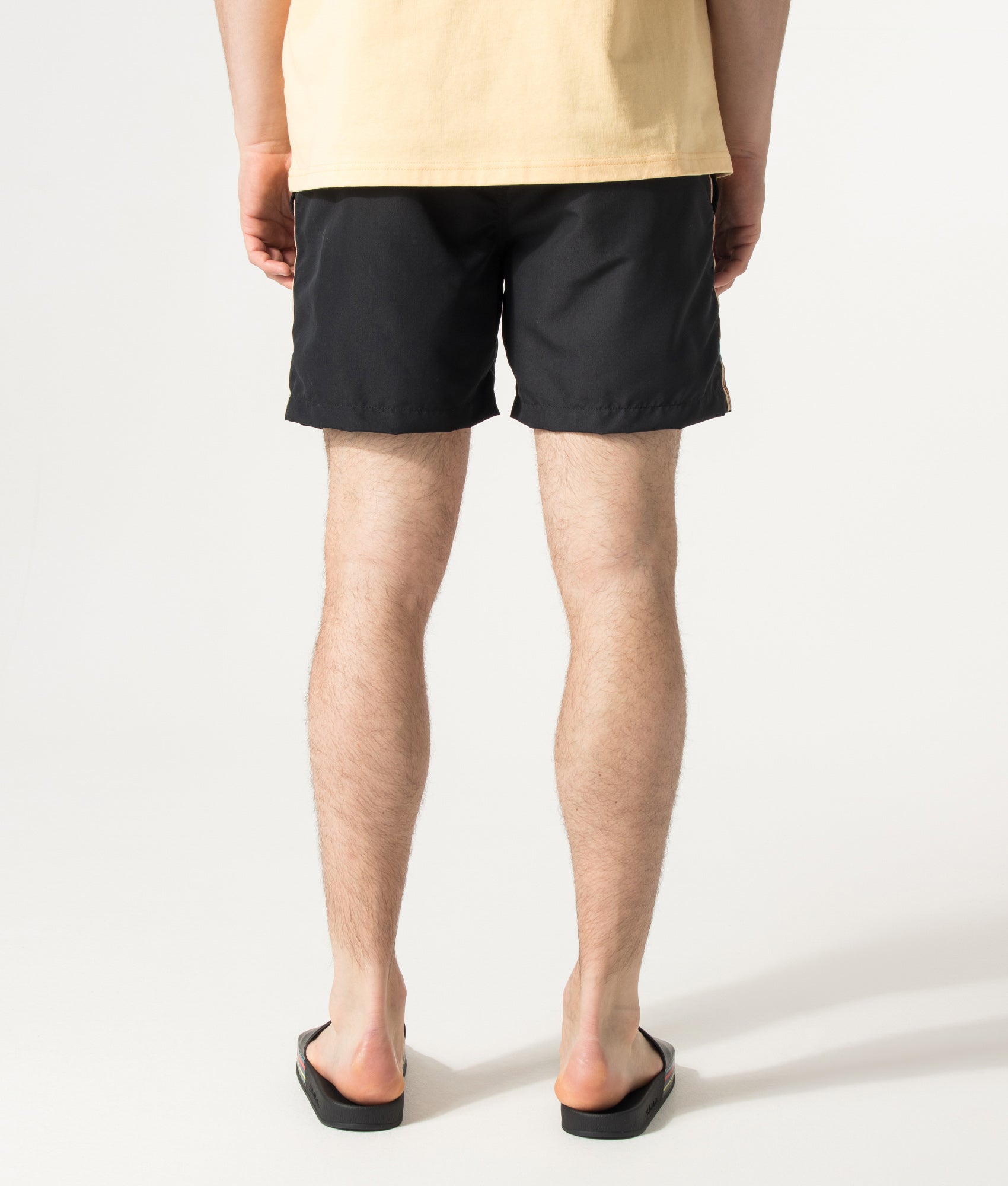 PS Paul Smith Signature Stripe Swim Shorts in Black at EQVVS Menswear. Model back shot.