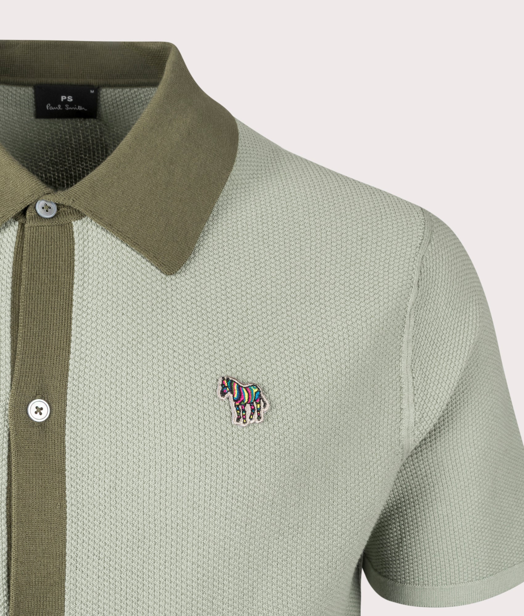 PS Paul Smith Zebra Badge Sweater Polo Shirt in green. EQVVS Detail Shot.