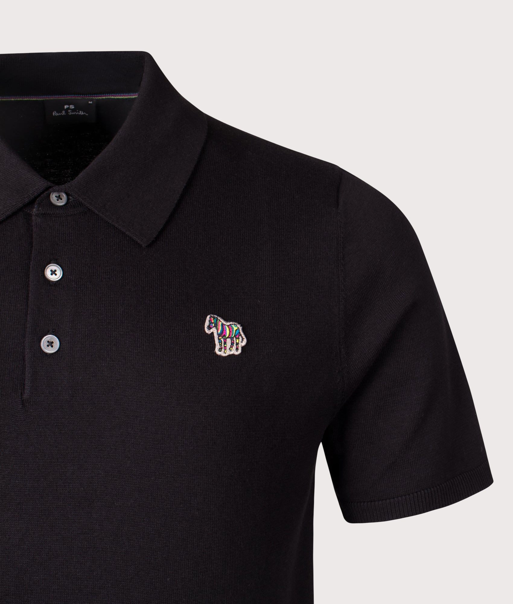 Zebra Badge Polo Shirt. Shot by EQVVS. Detail shot.