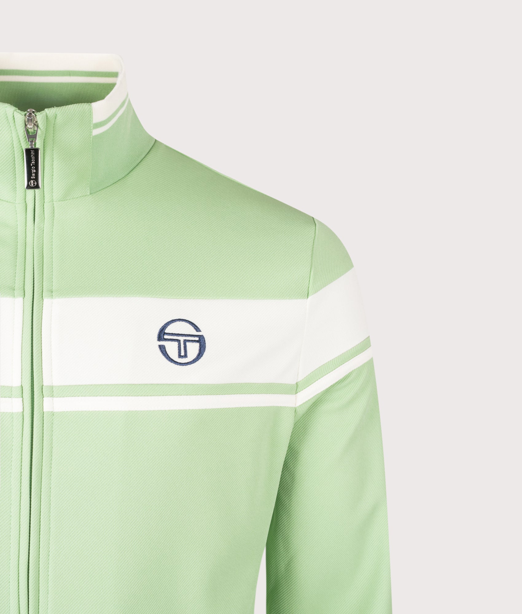 Sergio Tacchini Damarindo Track Top in Quiet Green and Gardenia at EQVVS Menswear. Detail shot.
