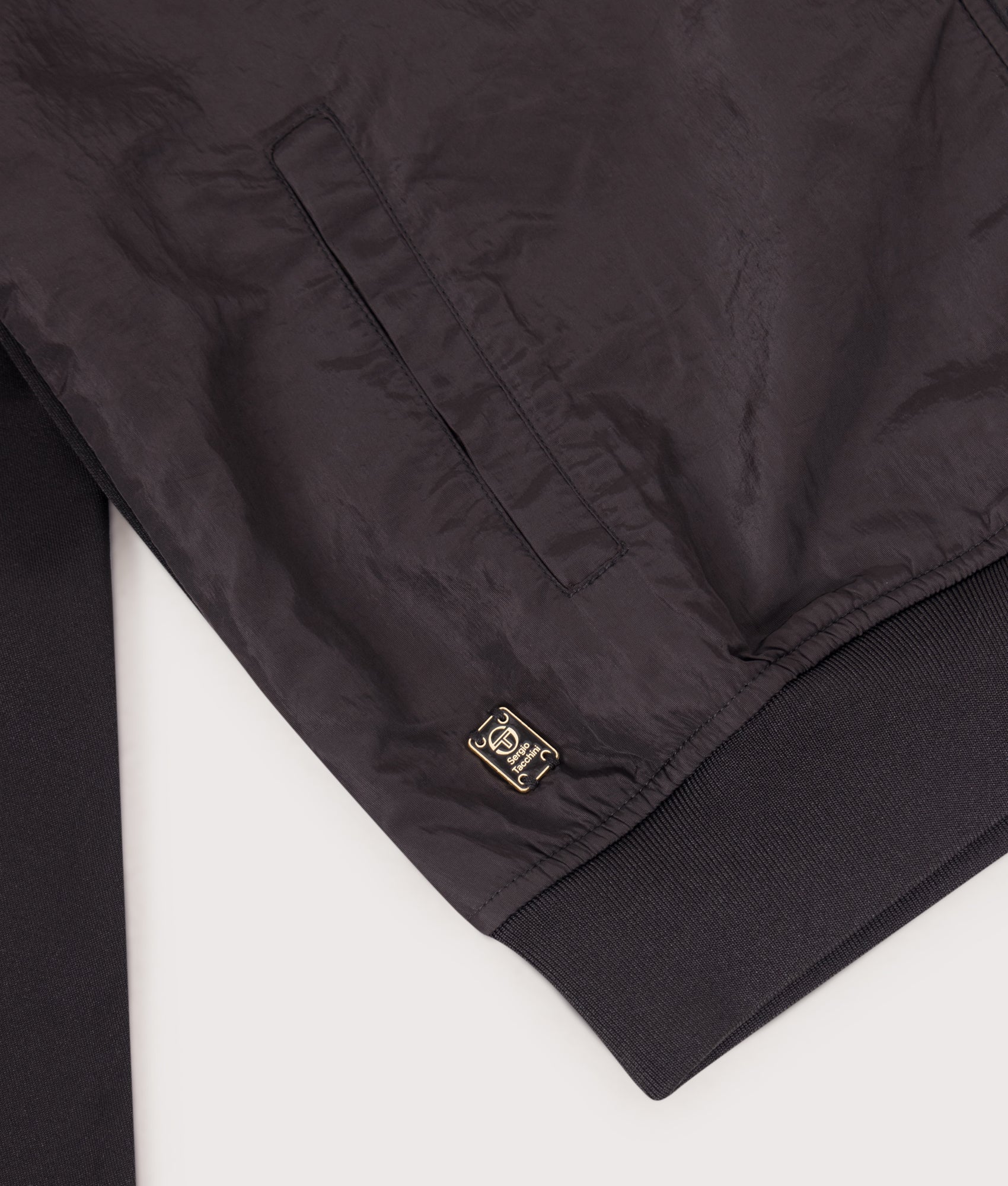 Cassio Track Top in Black by Sergio Tachinni. Shot by EQVVS. Bottom Detail shot.
