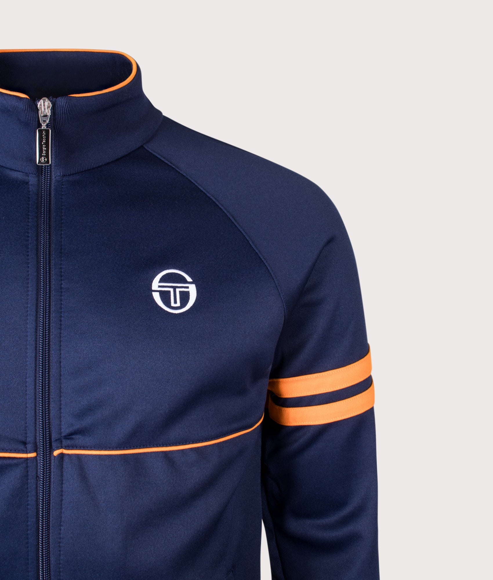 Sergio Tacchini Orion Track Top in Maritime Blue and Orange Pepper at EQVVS Menswear. Detail shot.
