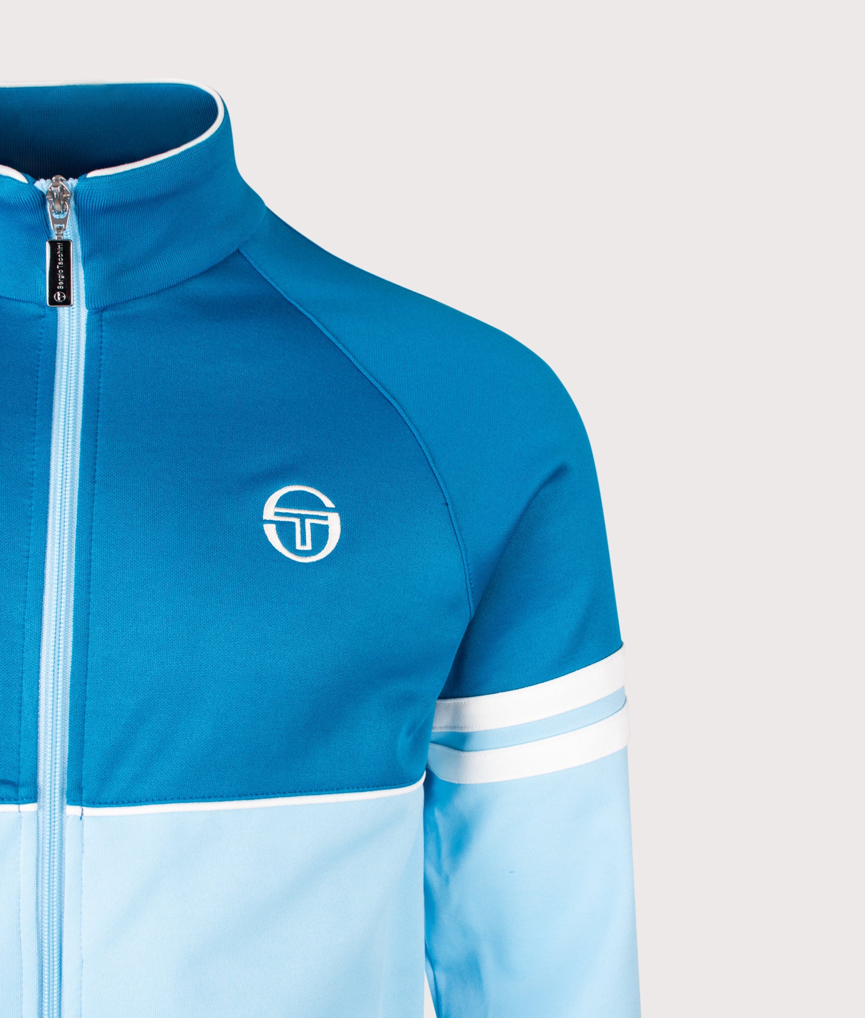 Sergio Tacchini Orion Track Top in Mykonos Blue, Baltic Sea and Gardenia at EQVVS Menswear. Detail shot.