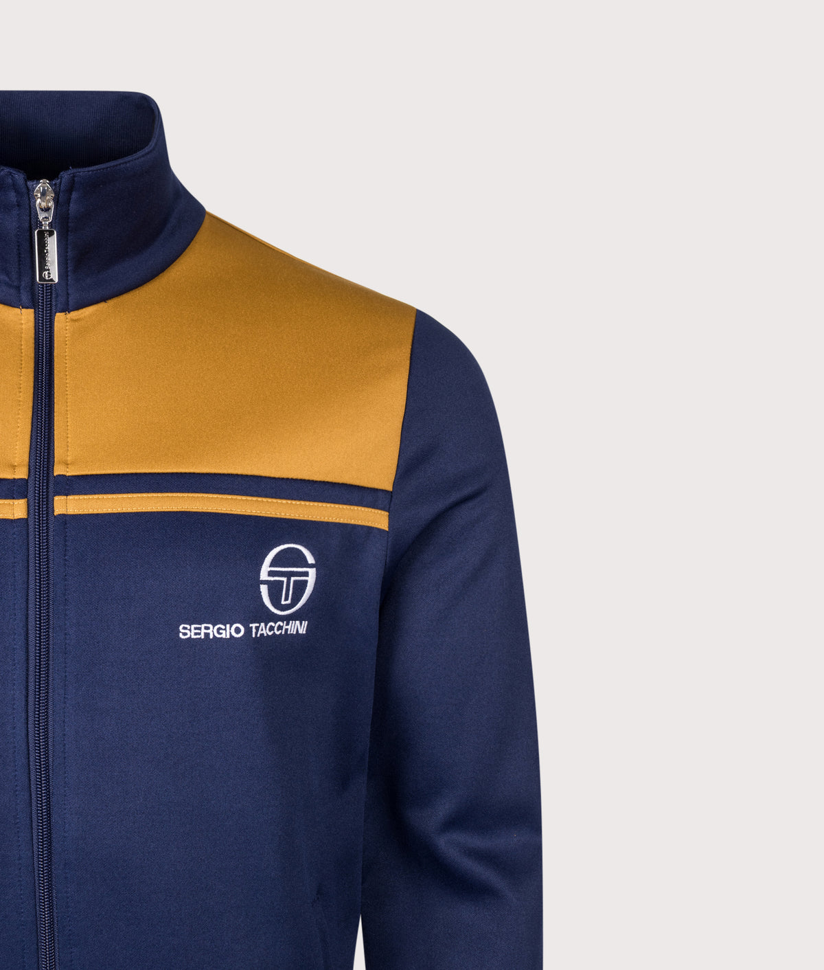 Sergio Tacchini Slim Fit New Young Line Track Top in Maritime Blue and Golden Brown at EQVVS Menswear. Detail shot.