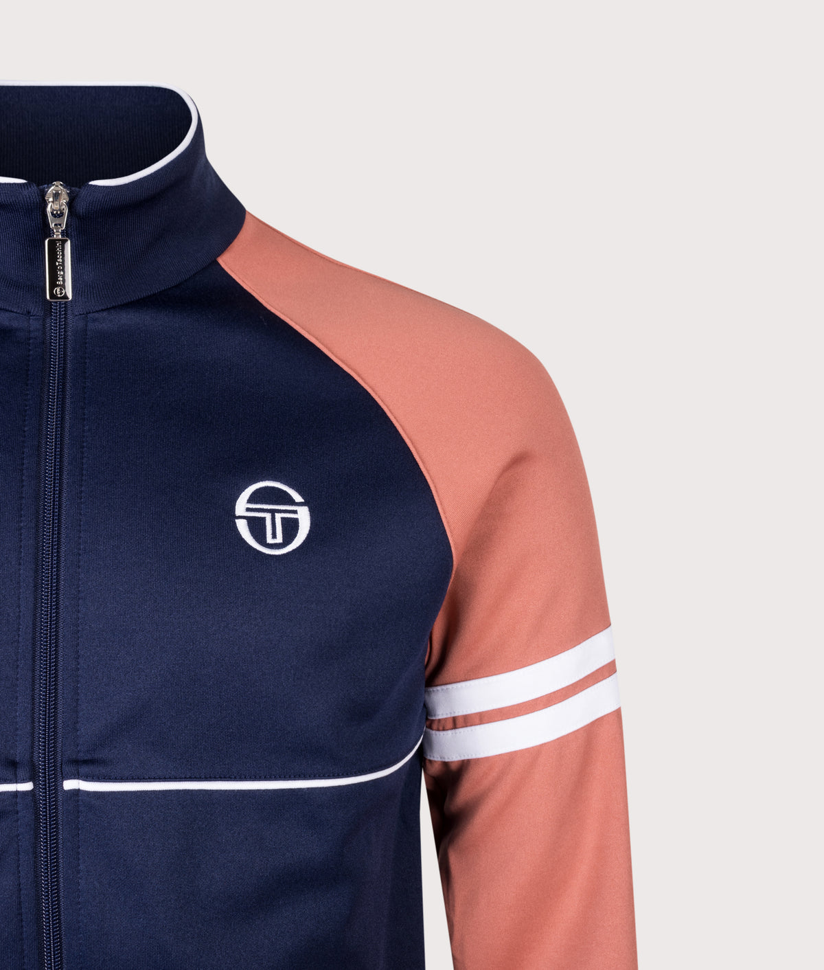 Sergio Tacchini Orion Track Top in Maritime Blue, Light Mahogany and White at EQVVS Menswear. Detail shot.