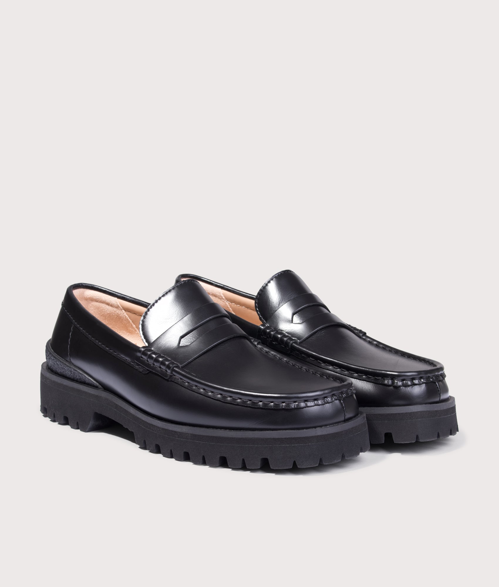 Clarks Originals Yukoner Penny Loafers in Black Leather at EQVVS Menswear. Angled front shot.