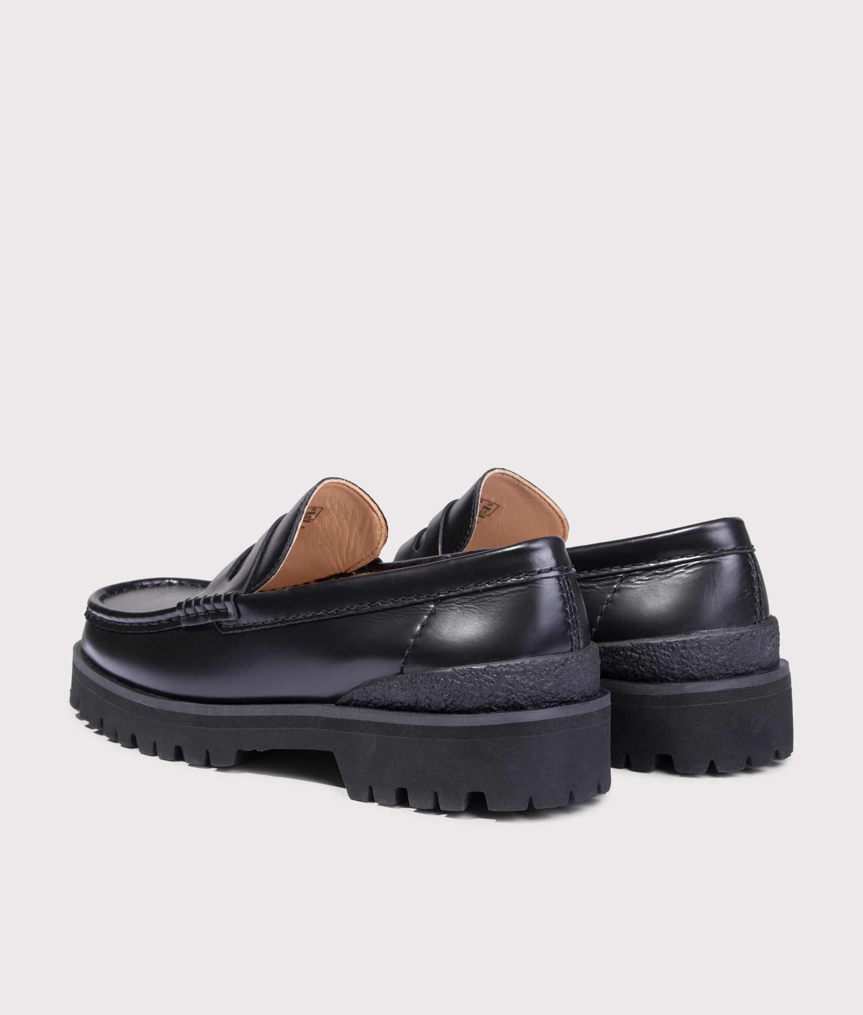 Clarks Originals Yukoner Penny Loafers in Black Leather at EQVVS Menswear. Angled back shot.