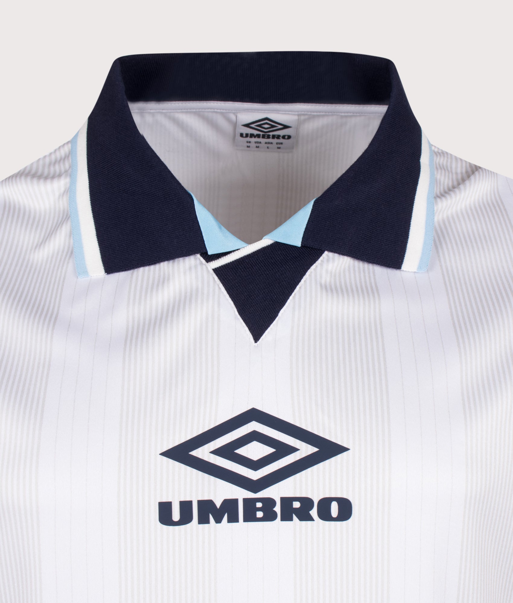 Umbro Tournament Football Jersey in white at EQVVS Menswear. Detail shot.
