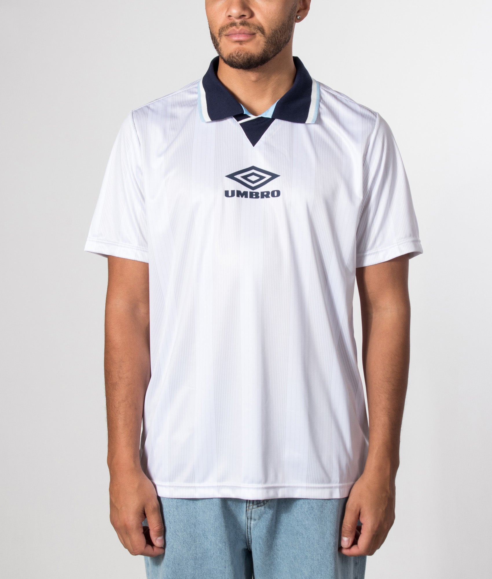 Umbro Tournament Football Jersey in white at EQVVS Menswear. Model front shot.