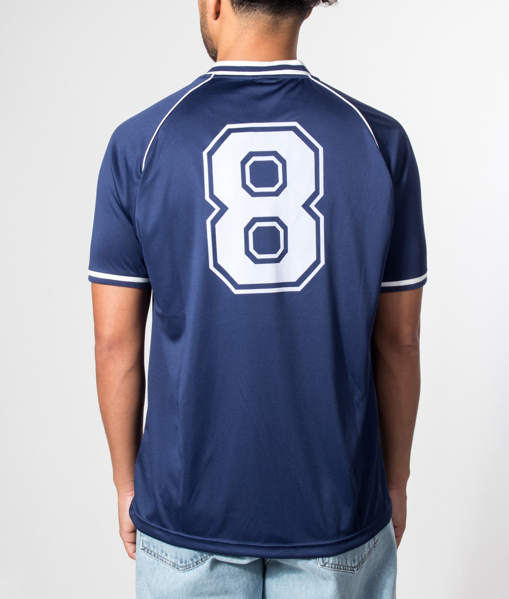 Umbro Jersey NR 8 in Patriot Blue at EQVVS Menswear. Model back shot.