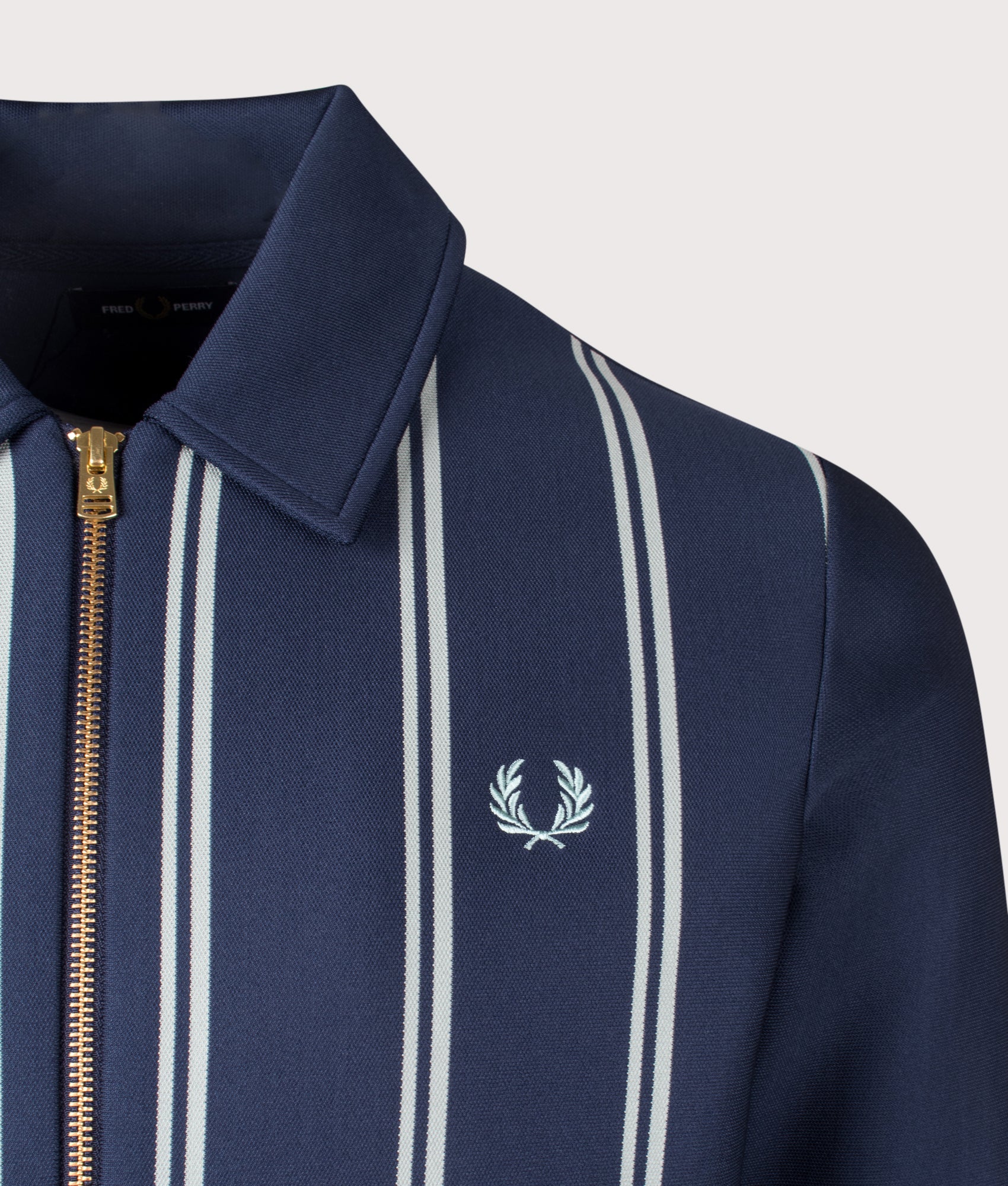 Striped Collared Track Top in Tennis Blue by Fred Perry. Shot at EQVVS.  Detail shot. 