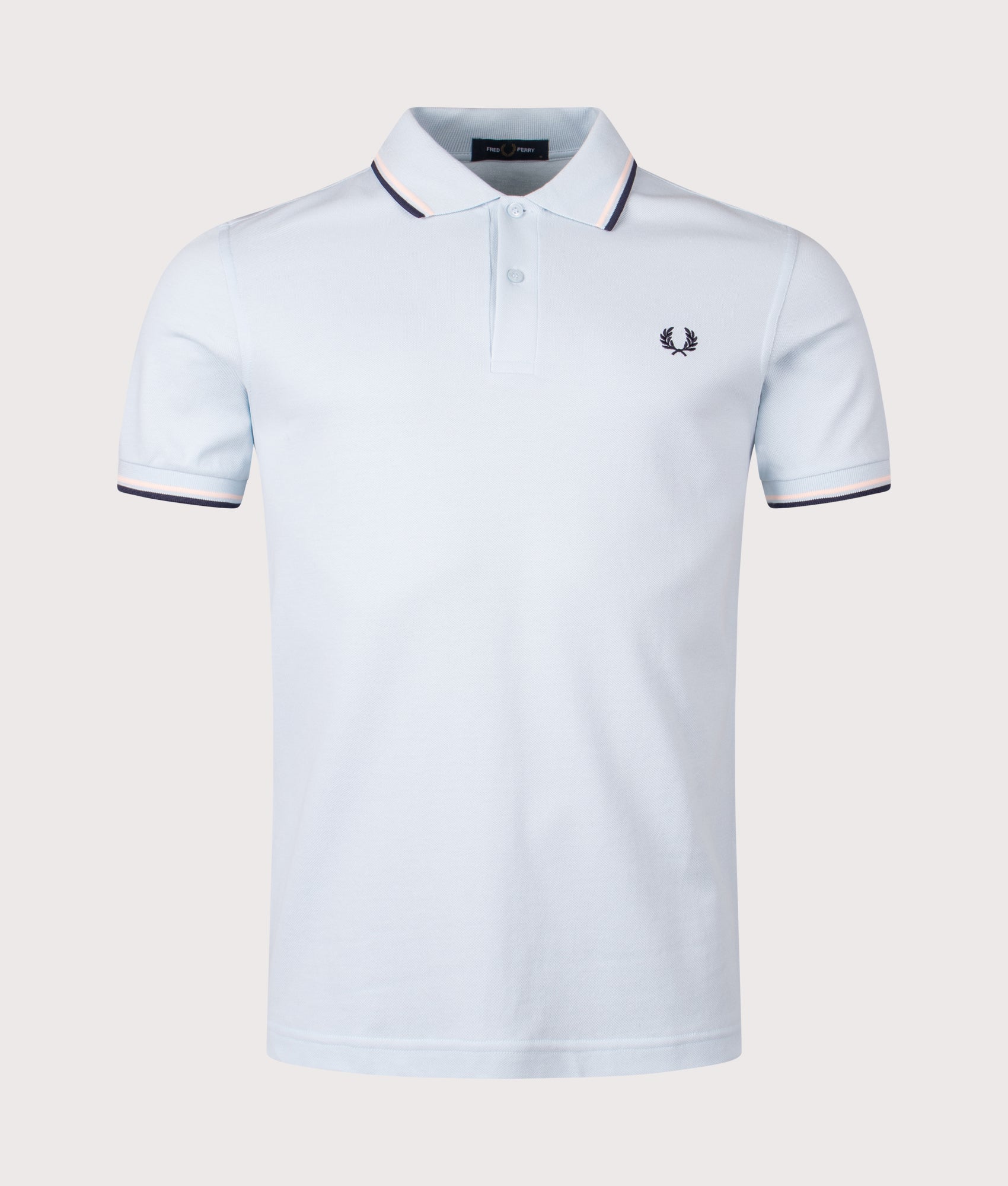 Fred Perry Twin Tipped Polo Shirt in Light Ice/Silky Peach/Tennis Blue at EQVVS Menswear. Front Shot