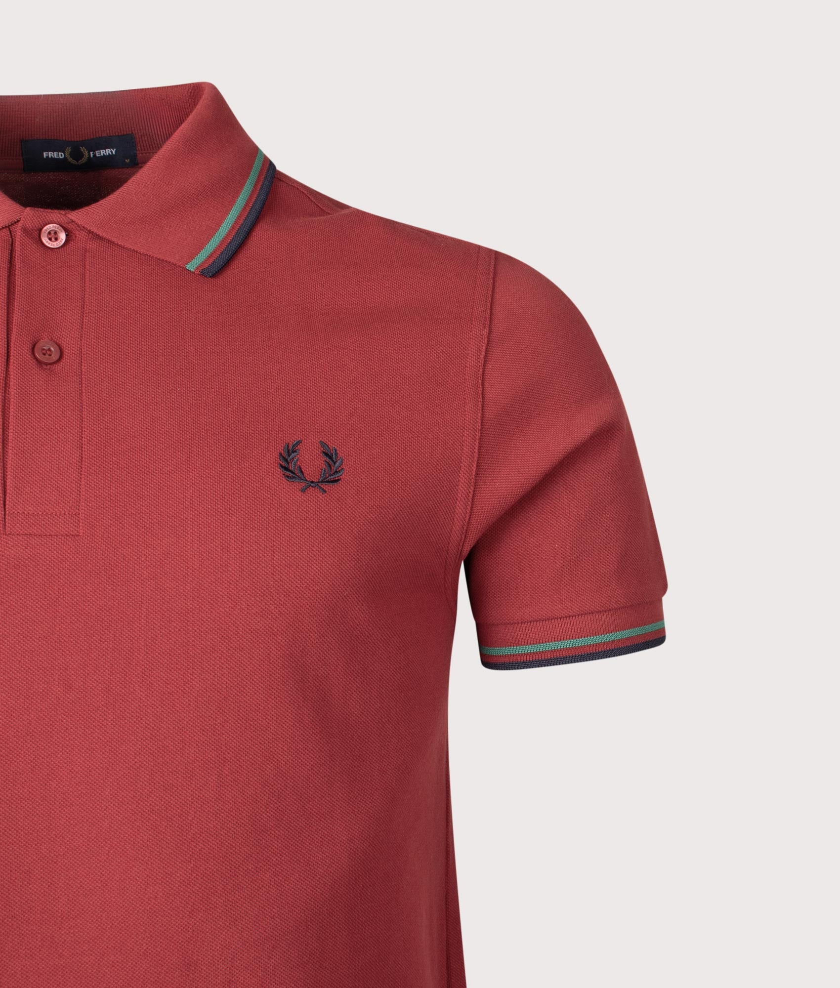 Twin Tipped Fred Perry Polo Shirt in Burnt Red/Sport Green/Navy | 100% Cotton | Shot at EQVVS | Detail shot 