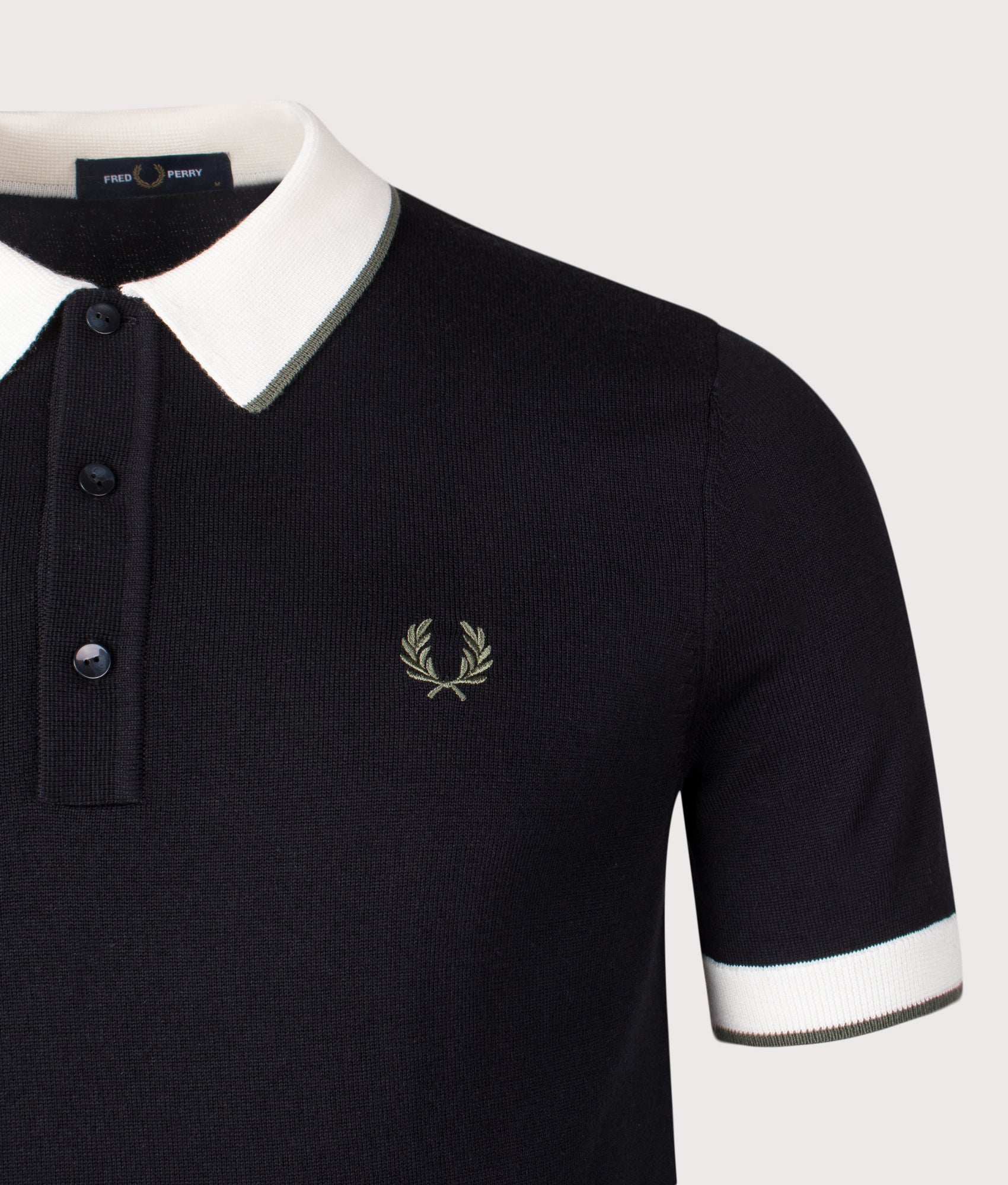 Fred Perry Contrast Tipped Knitted Polo Shirt in Black at EQVVS Menswear. Detail shot.