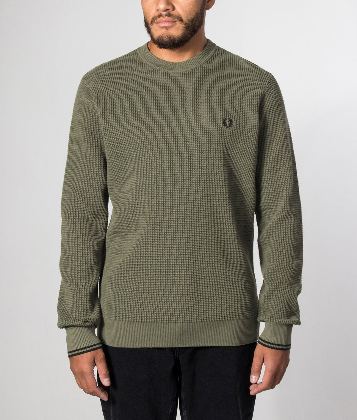 Fred Perry release the Regular Fit Waffle Stitch Jumper in Laurel Wreath Green at EQVVS Menswear. Model front shot.